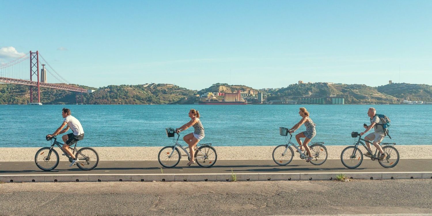 People cycling along a sea front