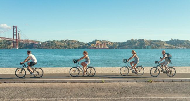 People cycling along a sea front